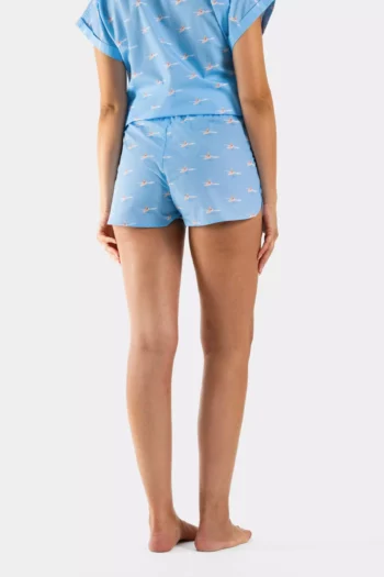 Short femme en popeline de coton, imprimé fond bleu vague et surfeuses. Léger, original et parfait pour un look estival.